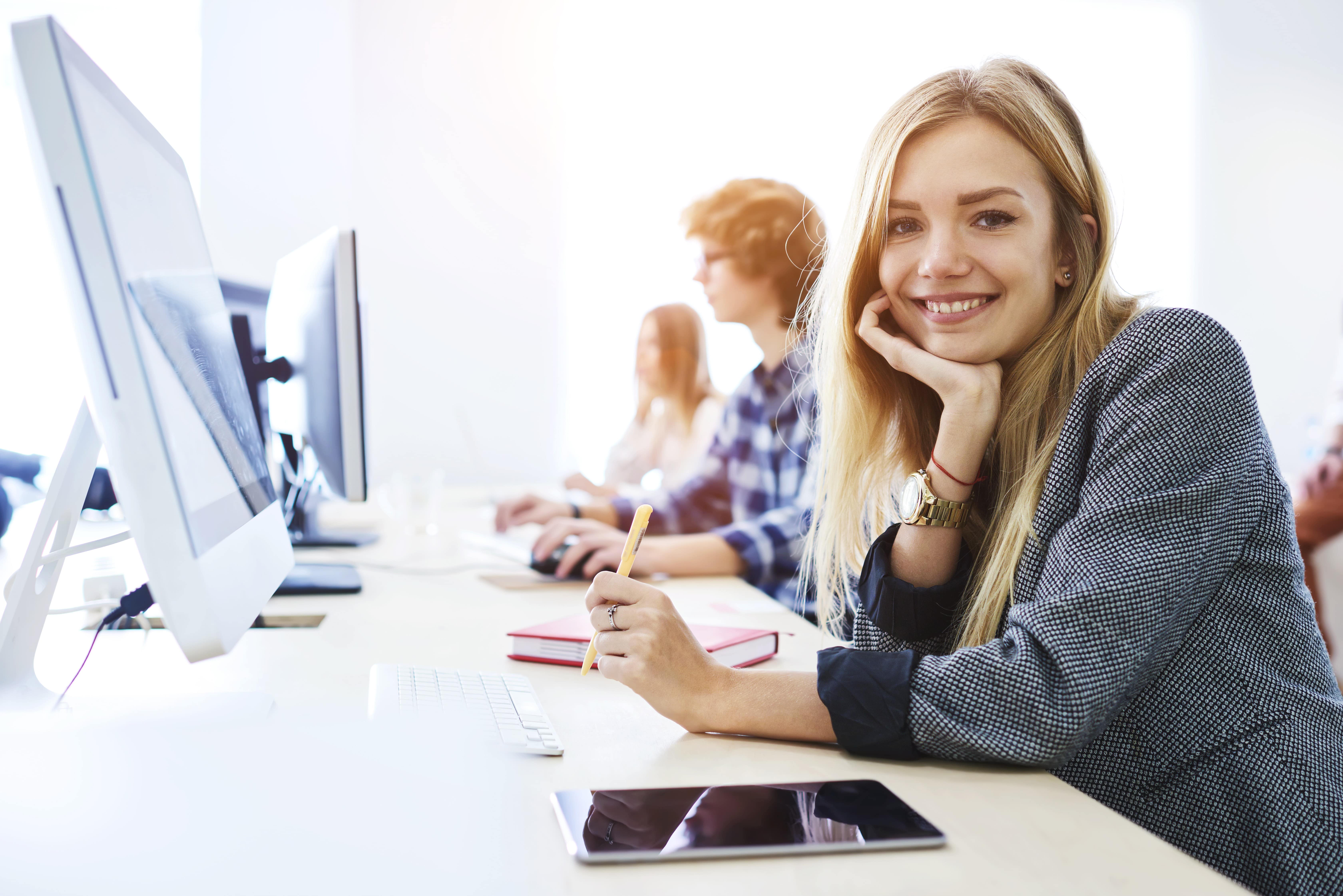 Smiling Student in Front of a Computer