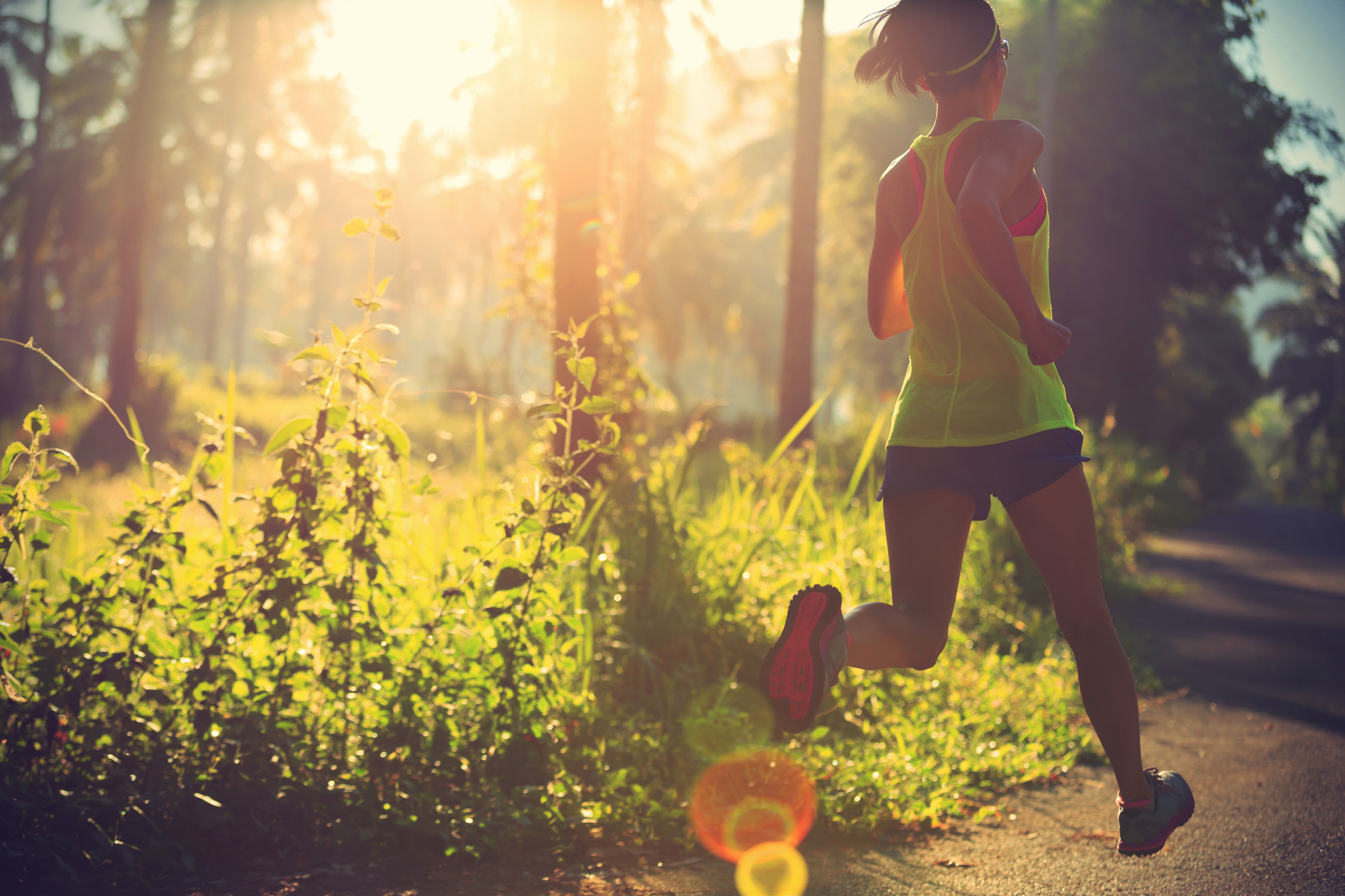 Woman Running at the Forest Trail